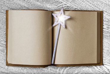 shining star wand sitting on an open book